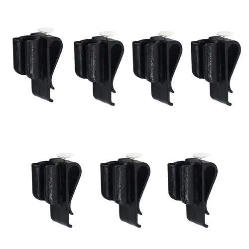 Seven black plastic golf putter clips laid out in a row